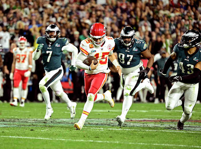 Patrick Mahomes runs for a first down as Eagles defenders give chase in the fourth quarter of Super Bowl LVII